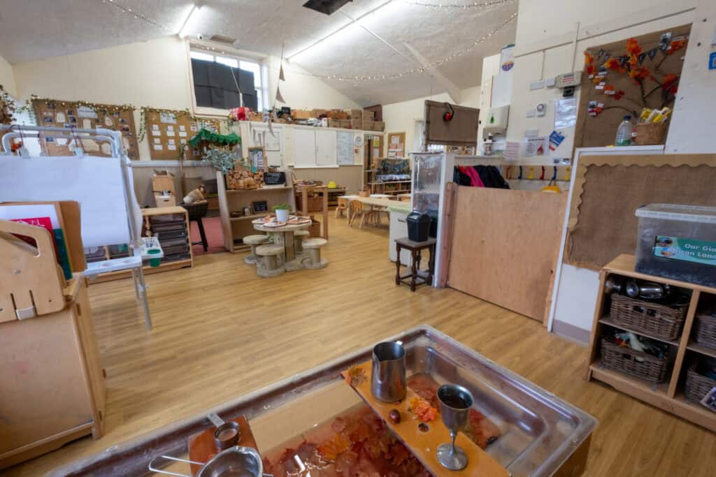 Bright and welcoming indoor play area at Thrive Childcare, featuring wooden furniture, educational toys, and creative activity stations for children's development and fun.