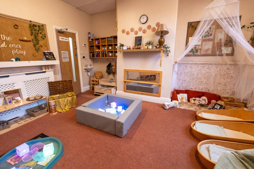 Bright colourful indoor playroom at Thrive Childcare with soft beds, toys, educational materials, and a cosy corner for children’s activities and relaxation. Suitable for early childhood development and learning.