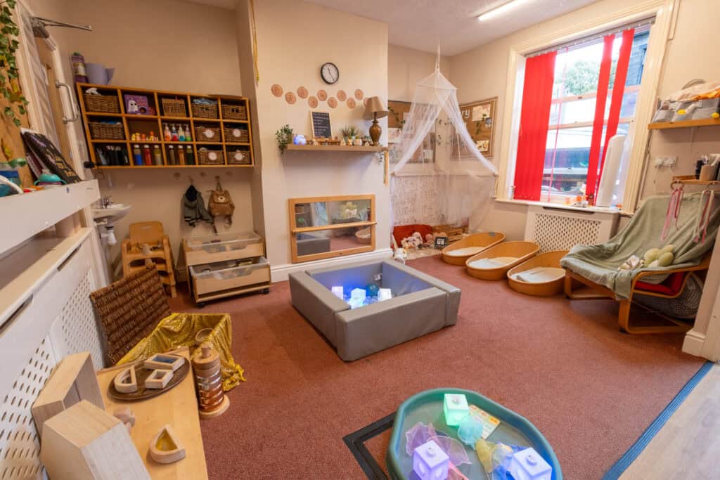 Bright, welcoming childcare playroom with toys, cosy areas, and natural light, ideal for early childhood development and learning at Thrive Childcare.