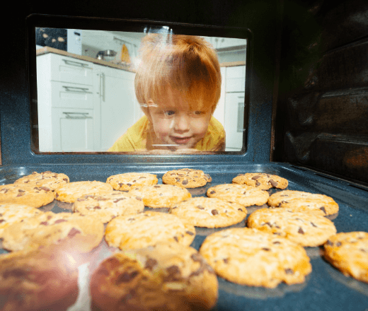 Kids enjoying baking cookies in a bright, family-friendly childcare environment at Thrive Childcare. Safe, nurturing space for early childhood development and learning activities.