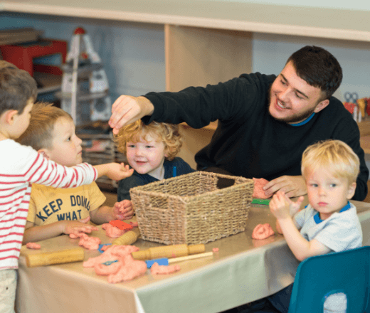 Bright young children engaging in creative play with caring childcare staff at Thrive Childcare in a warm, safe environment.