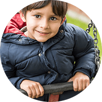 Bright young boy enjoying outdoor play at Thrive Childcare, promoting early childhood development and safe learning environments in the UK.