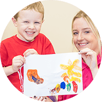 Bright smiling children engaging in creative art activities at Thrive Childcare, fostering early development and learning in a caring environment.