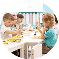 Bright young children enjoying a nutritious outdoor meal at Thrive Childcare, promoting healthy eating and social development in a safe, supportive environment.