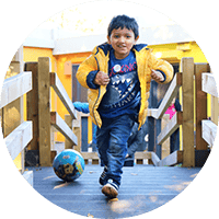 Bright young boy playing outdoors at Thrive Childcare, embracing early childhood education, fun, and development in a safe, nurturing environment.