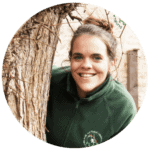 Bright smiling childcare staff member outdoors at Thrive Childcare, ensuring children’s well-being and fostering a nurturing environment.