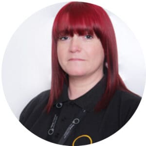 Bright red-haired childcare professional at Thrive Childcare, dedicated to early childhood education and child development. Friendly staff committed to providing a safe, nurturing environment for children.