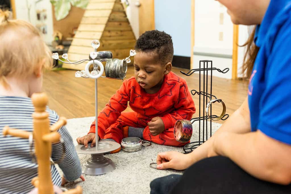 Children engaging with educational toys at Thrive Childcare, promoting early learning and development in a safe, nurturing environment in the UK.