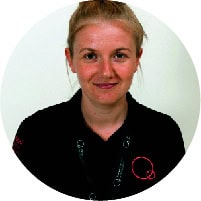 Bright young childcare professional with friendly smile in Thrive Childcare setting, promoting early childhood development and quality care for young children in a nurturing environment.