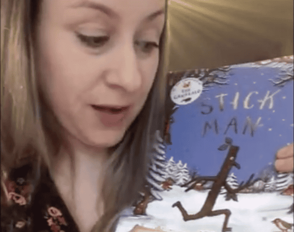 A young woman reading a children's book titled "Stitch Man" at Thrive Childcare, showcasing engaging early childhood literacy activities in a welcoming childcare environment.