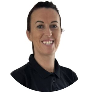 Bright smiling childcare professional in black uniform, supporting early childhood education.