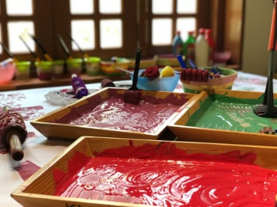 Colourful finger painting activity for children at Thrive Childcare, fostering creativity and early learning in a safe, nurturing environment.