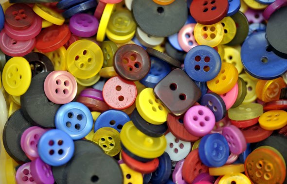 Colourful plastic buttons for children's arts and crafts activities at Thrive Childcare, promoting creative learning and sensory development in a vibrant childcare environment.