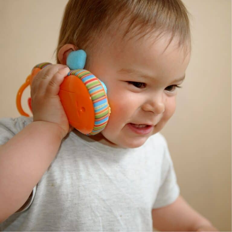 Bright young child wearing colourful headphones, enjoying playful learning at Thrive Childcare, a trusted place for early childhood education and care.