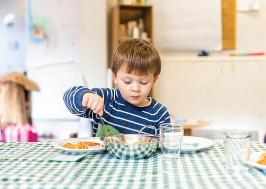 A young boy enjoying a nutritious meal at Thrive Childcare, promoting healthy eating and care for children.