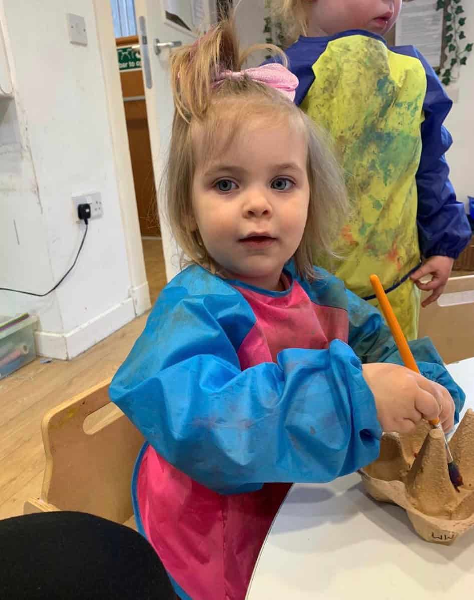 Little girl engaging in creative arts and crafts activities at Thrive Childcare, demonstrating a colourful and nurturing environment for early childhood development.
