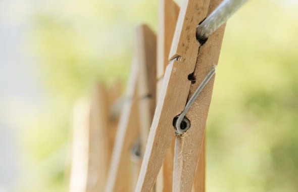 A close-up of wooden climbing frames for children in an outdoor play area, promoting active play and physical development at Thrive Childcare.