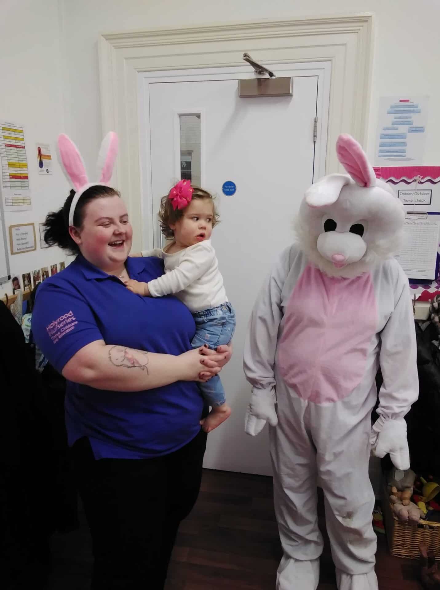 Cute children with bunny ears and a person in a bunny costume celebrating at Thrive Childcare, showcasing childcare, children's activities, and fun events in a welcoming early years environment.