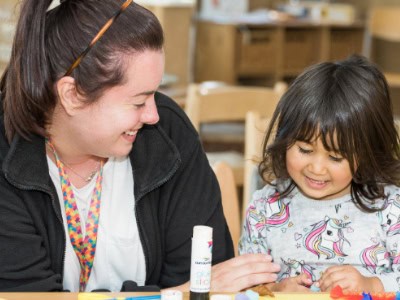Bright young girl and caring childcare worker engaging in creative play at Thrive Childcare, a trusted early childhood education centre promoting safe, nurturing environments for children's development.