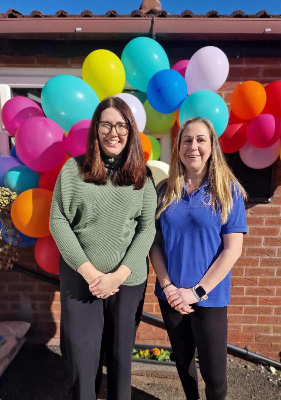 Brightly coloured balloons at Thrive Childcare, celebrating a special event with staff members outside the childcare centre. The cheerful atmosphere highlights quality early childhood education and caring childcare services.
