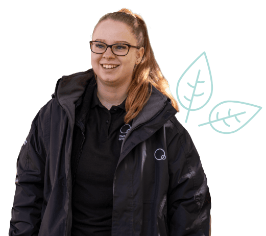 Dedicated childcare professional in Thrive Childcare uniform with a friendly smile, promoting quality early childhood education and nurturing environments for children’s development.