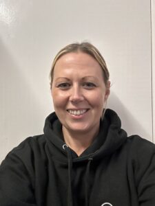 Friendly childcare provider at Thrive Childcare offering nurturing support and educational activities in a welcoming environment for young children.