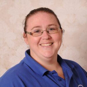 Caring childcare staff member smiling, promoting safe and nurturing early childhood education at Thrive Childcare centre.