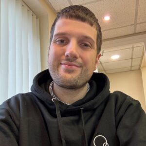 Friendly male staff member at Thrive Childcare, providing attentive early childhood education and care in a warm, welcoming environment.