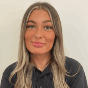 Nursery manager smiling in childcare setting, promoting early childhood education and development at Thrive Childcare, dedicated to nurturing young children in a safe environment.