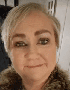 A woman with short, stylish blonde hair, smiling warmly, demonstrating a welcoming environment at Thrive Childcare, emphasising quality early childhood education and caring childcare services in the UK.