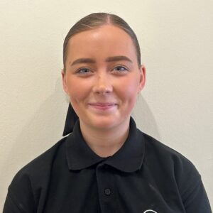 Bright young female caretaker smiling at Thrive Childcare, promoting caring children's nursery and early education services in the UK.