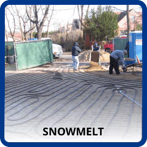 Two Aa Service Workers Install A Snowmelt System Under The Pavement, With Coiled Tubing Visible. Construction Materials And Trees Are In The Background.