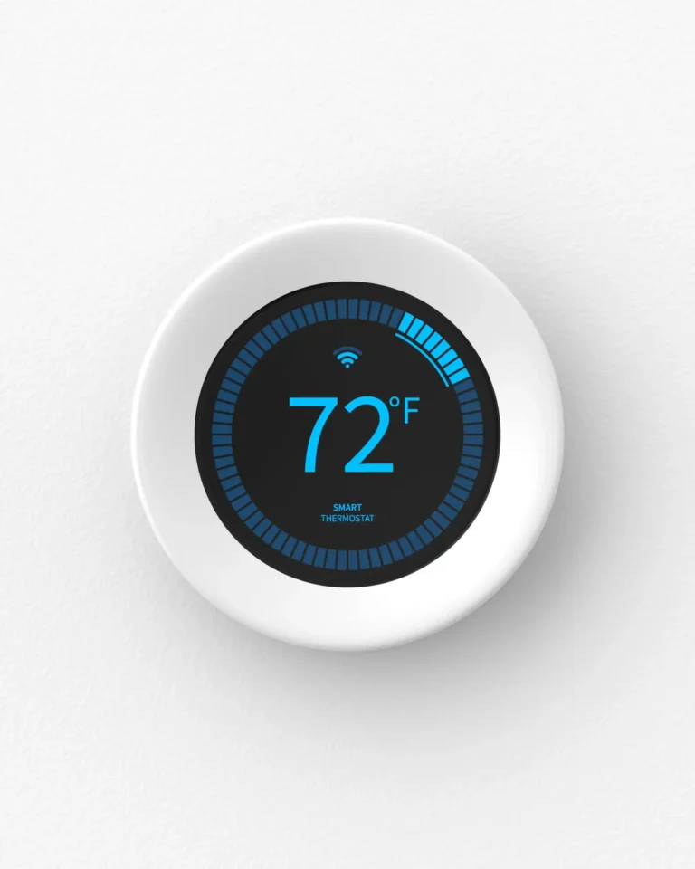 A round smart thermostat displays a temperature of 72°F with Wi-Fi connectivity indicated on a white wall.