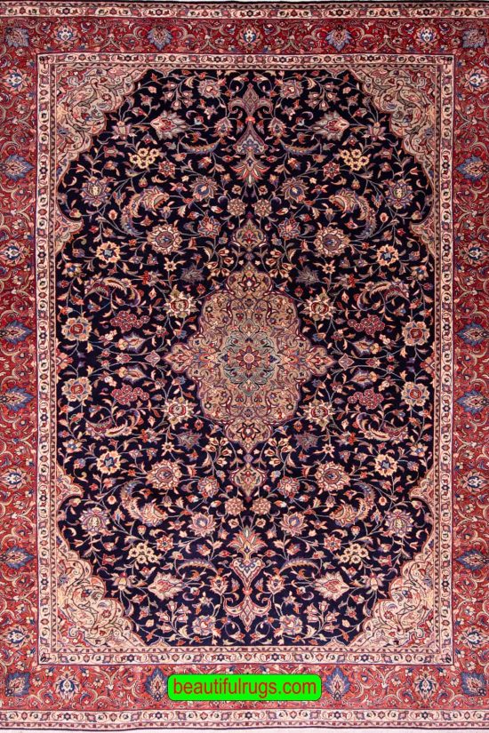 Hand knotted floral Persian Sarouk rug with navy blue filed and red border