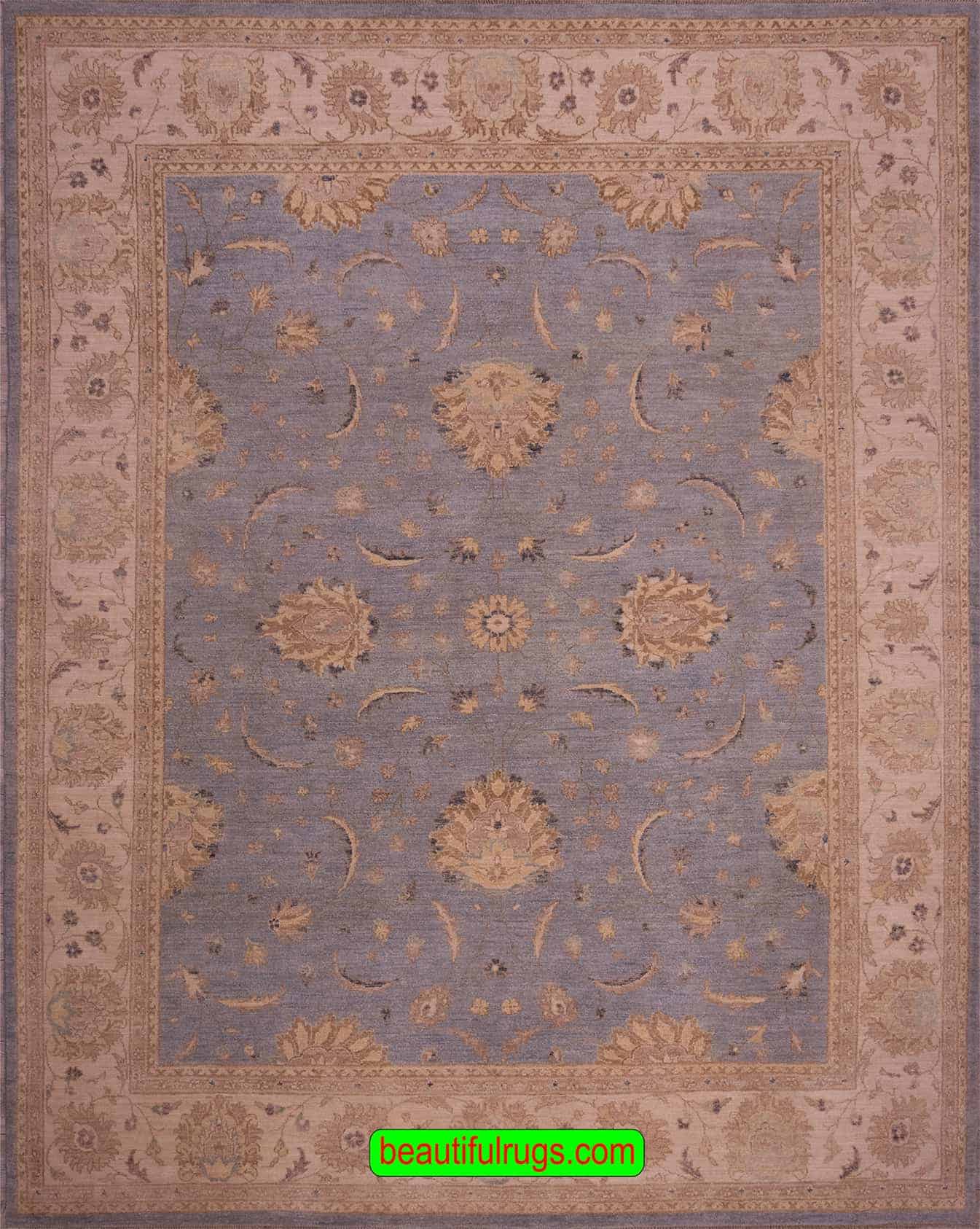 Vintage blue oriental rug with beige border, floral style. Size 8.1x10