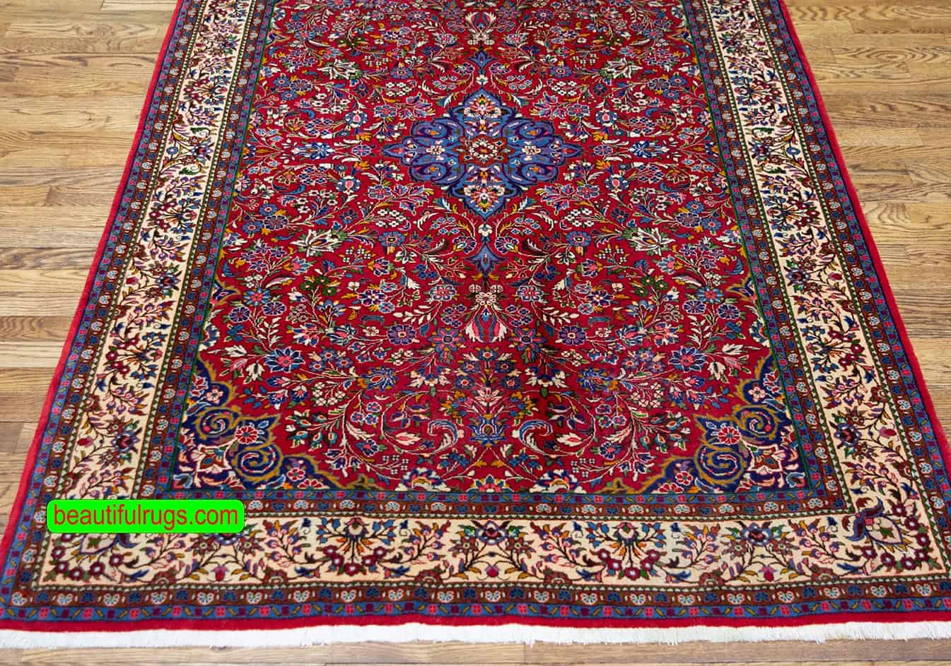 Handmade floral Persian Sarouk wool rug in red and beige colors. Size 4.3x6.9.