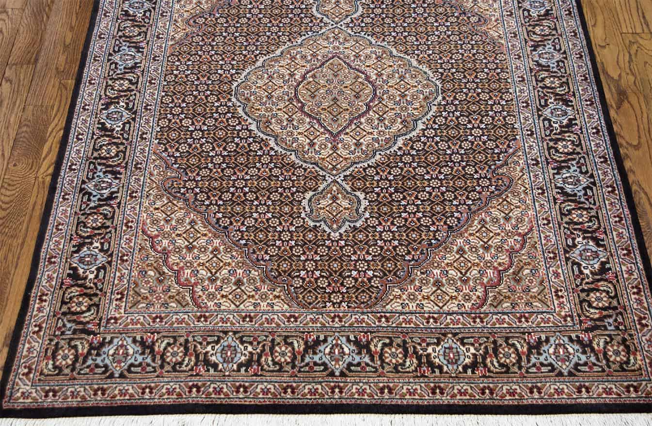 Hand knotted classic style Persian Tabriz carpet in black color made of wool and silk. Rug size 3.6x4.10.