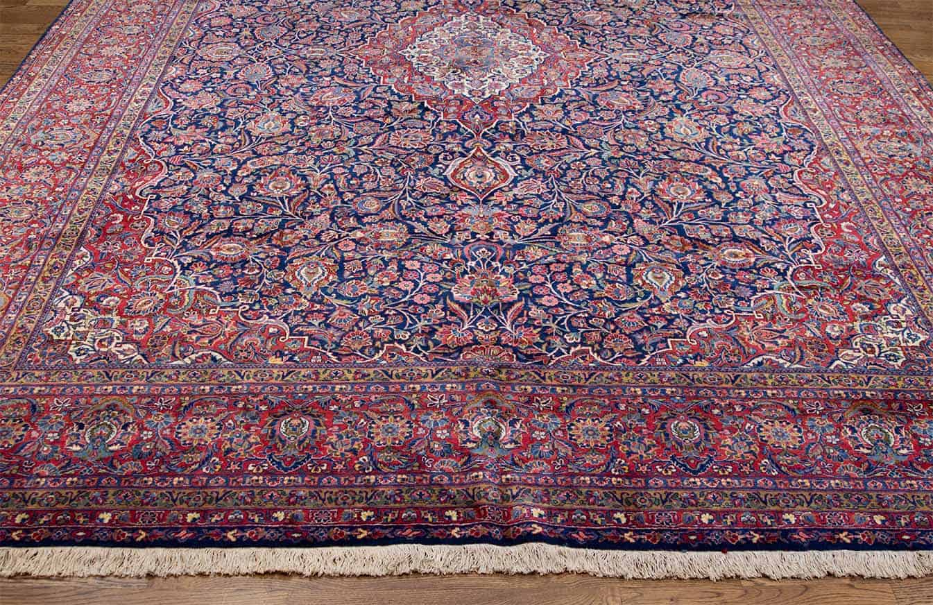 Real Persian rugs. A magnificent vintage floral Persian Kashan rug in navy blue and red border. Size 10.4x14.