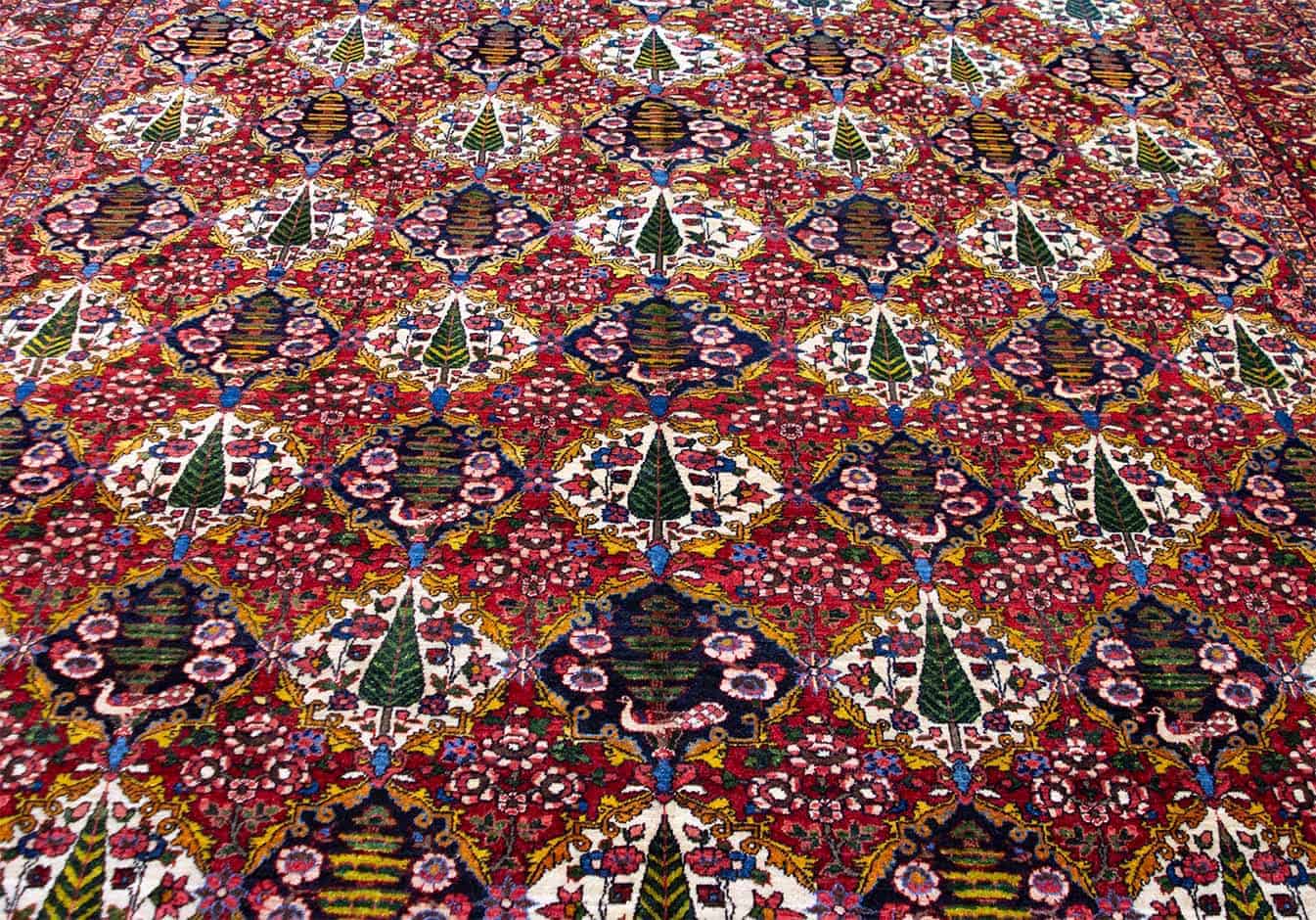Old Persian Bakhtiari rug in red color, garden design with pine tree. Size 10.2x13.5.