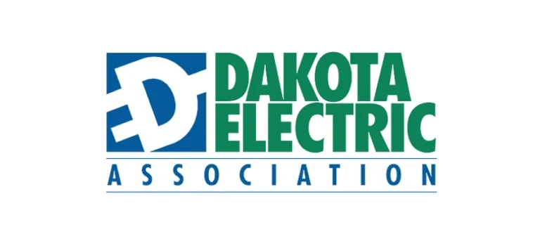 The logo of Dakota Electric Association showcases a stylized "D" with plug prongs in blue, alongside "DAKOTA ELECTRIC ASSOCIATION" in green and blue text, proudly representing Minnesota's commitment to sustainable energy and benefiting from tax credits.