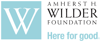The logo of the Amherst H. Wilder Foundation features a large "W" in a blue square, symbolizing their commitment to community welfare in Minnesota, accompanied by the text "Here for good.