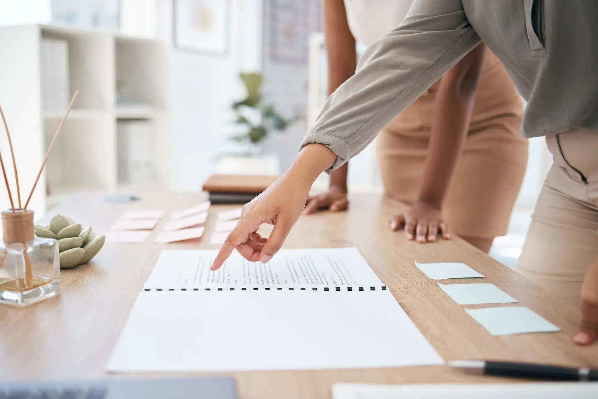Business women, pointing hands and documents in marketing target audience research, kpi data analys