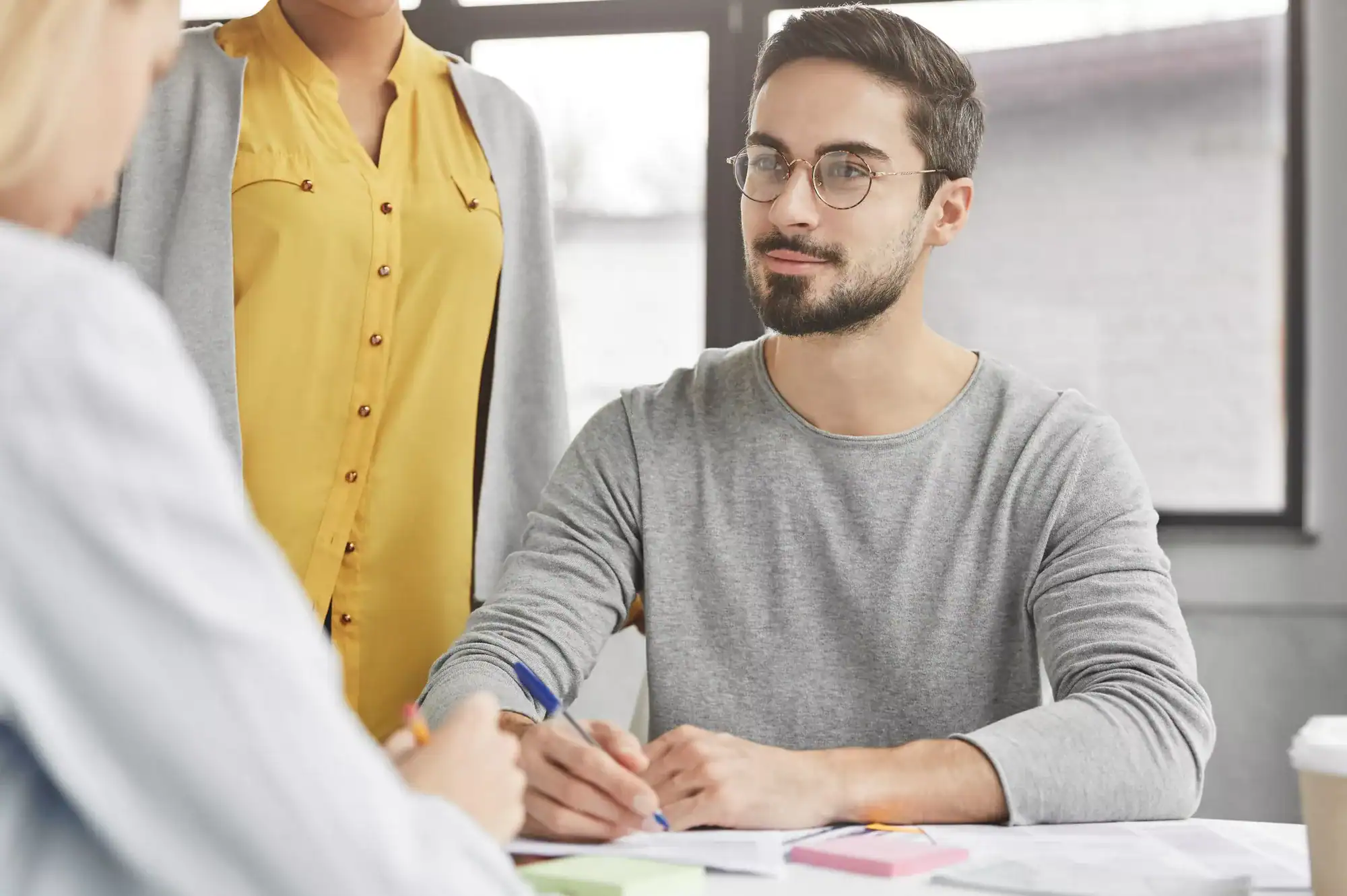 Bearded male employer communicates with job applicant, conducts interview with expert in economy fie