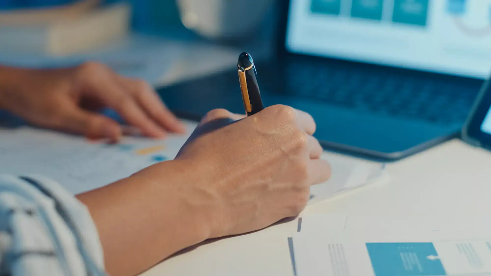 Close-up young asia lady freelance focus on laptop write worksheet finance at house.