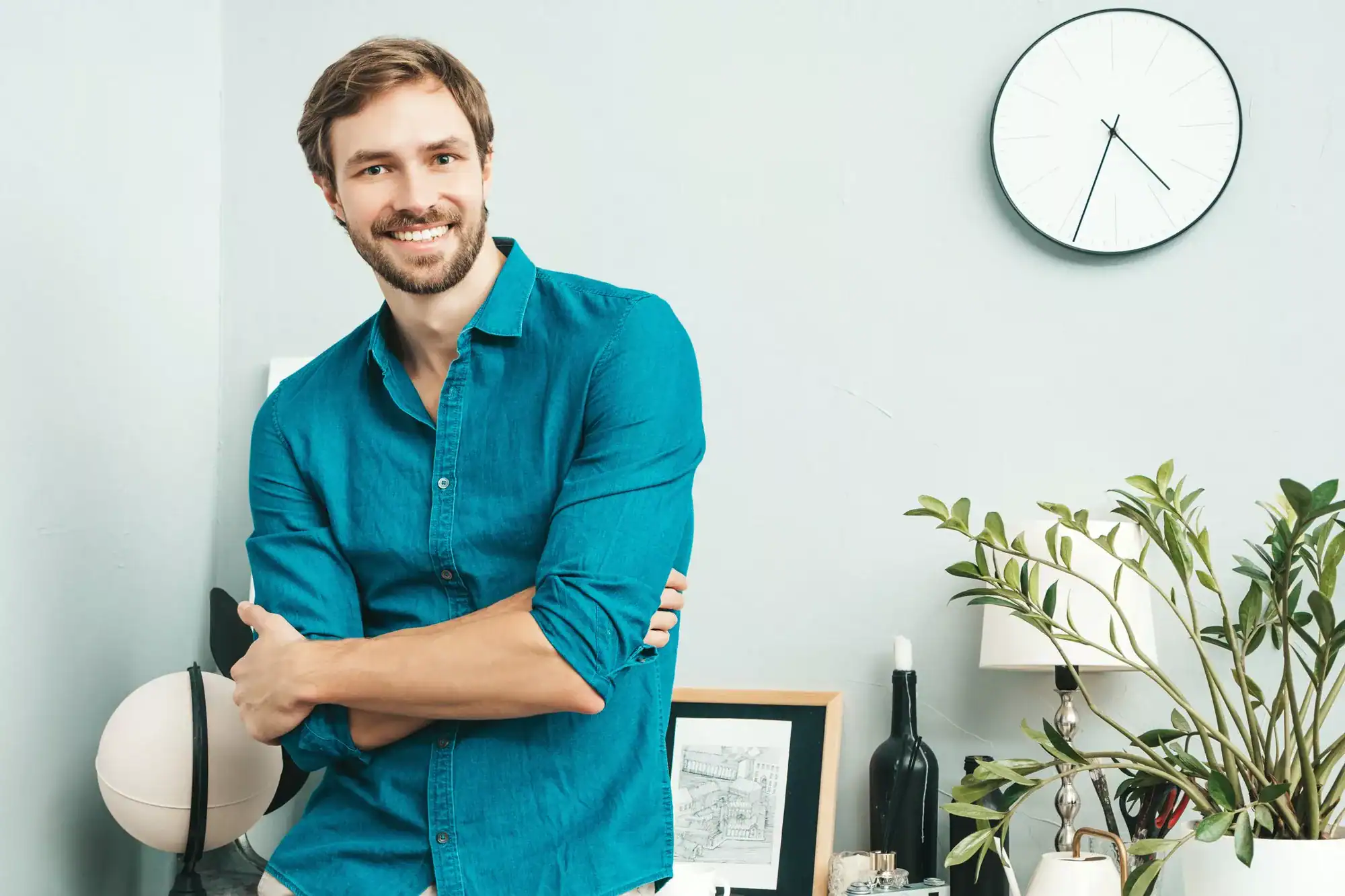 Portrait of young handsome man posing in the office