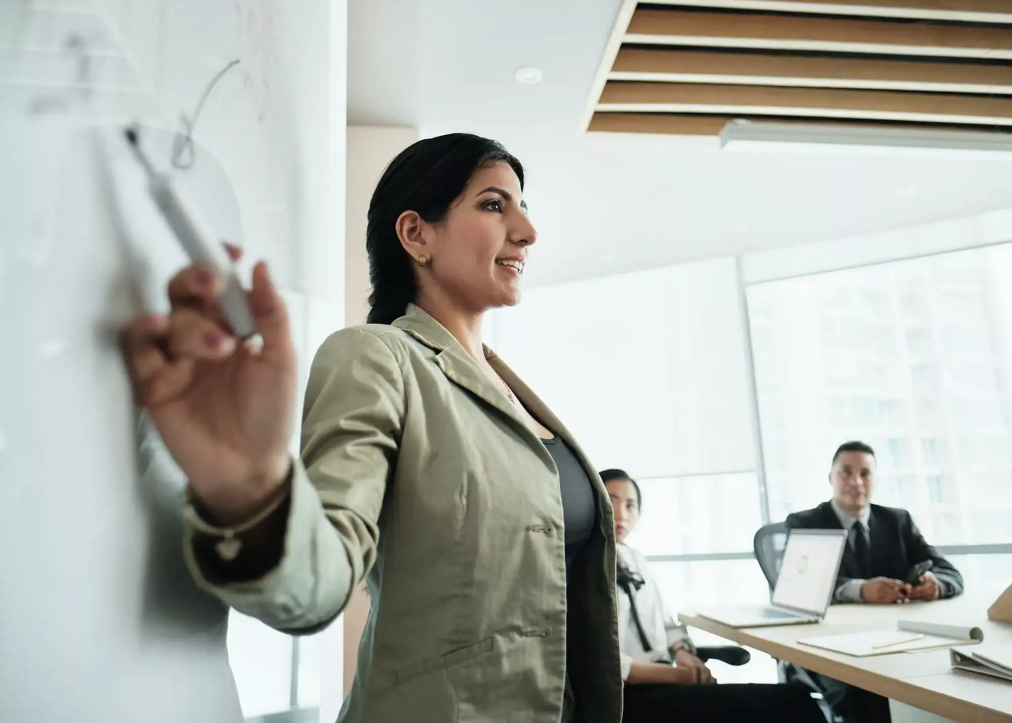 Woman Doing Presentation With Board In Office Meeting Room