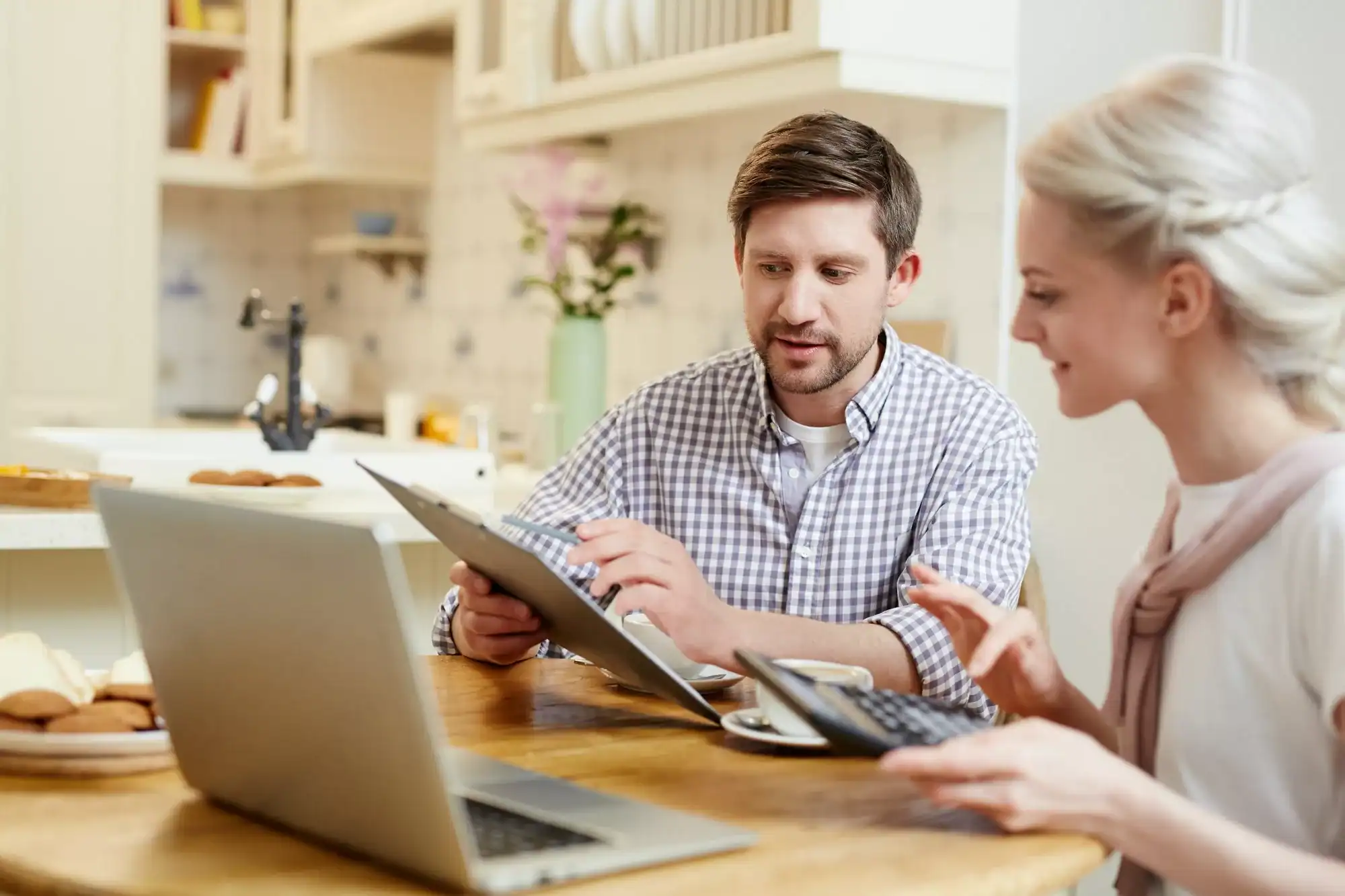 Young couple discussing finances at kitchen