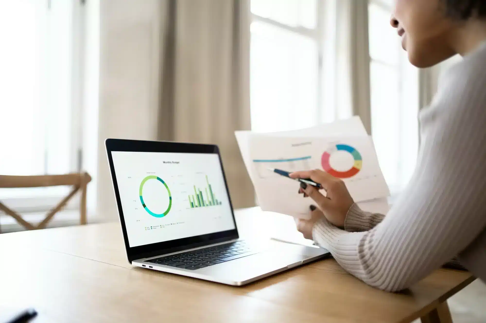 Uses a laptop woman with glasses manager in the office report finance and budget in the company