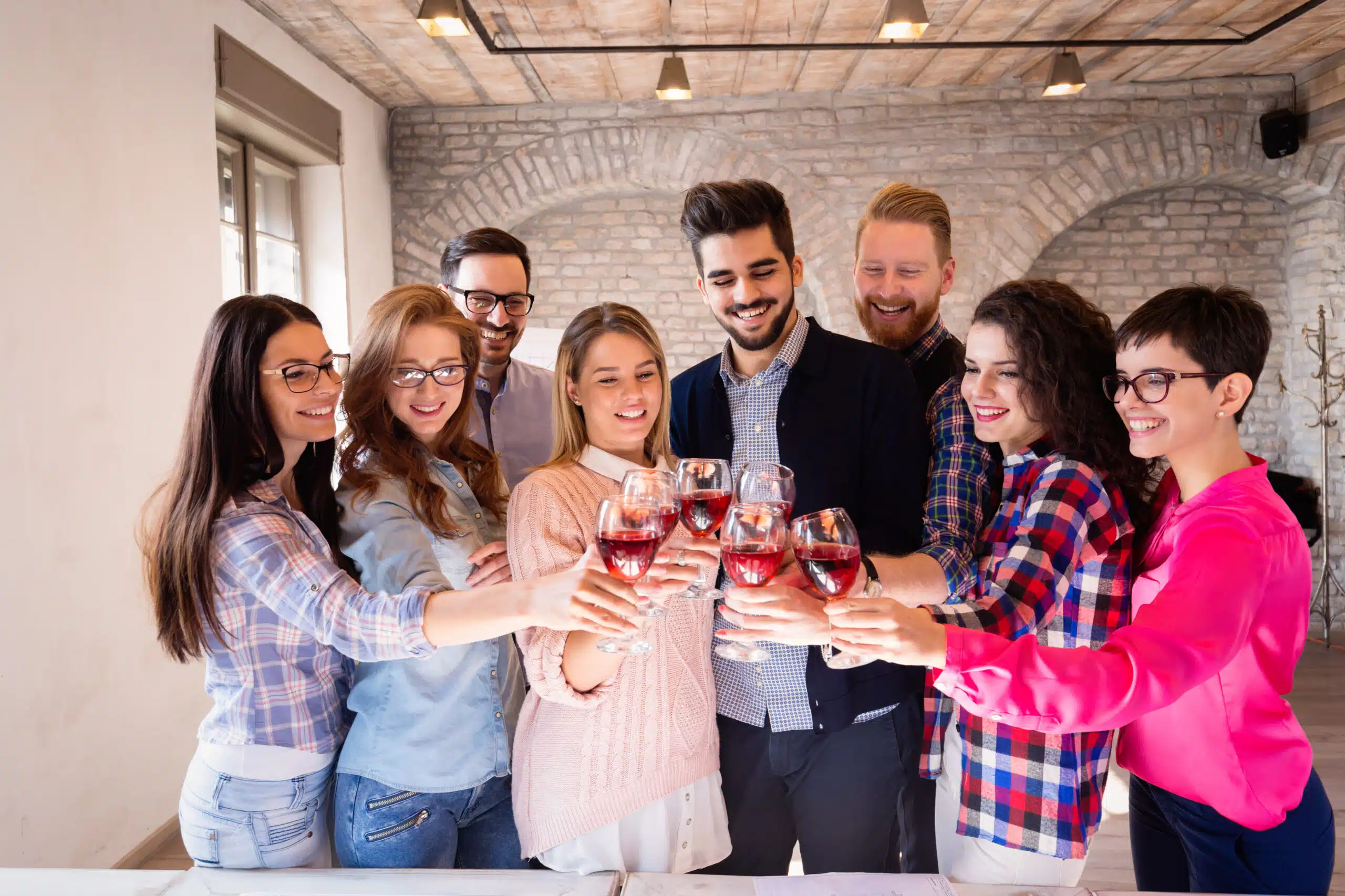 Group of successful architects celebrating in office