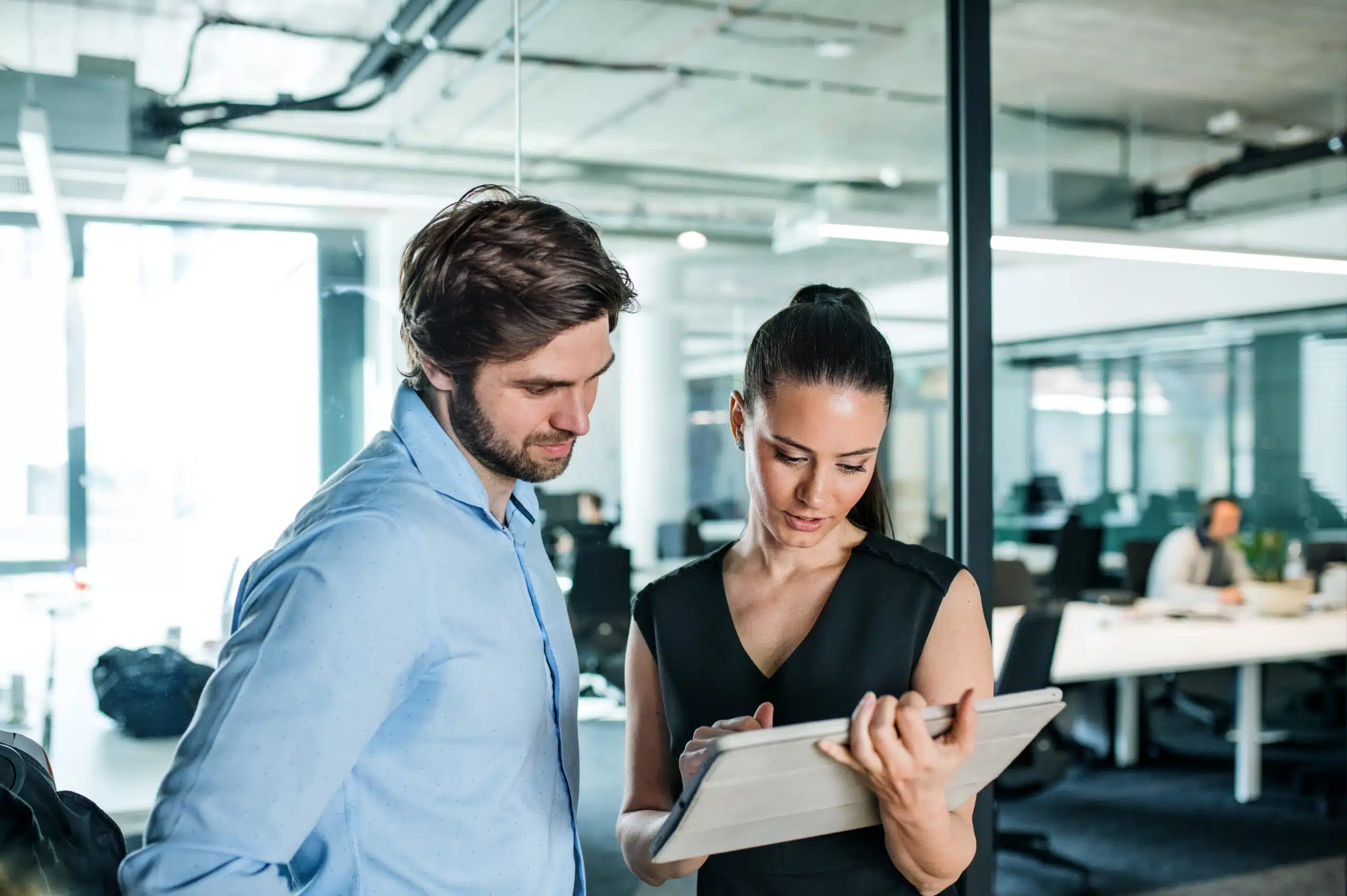 Young businesspeople with tablet in an office, working